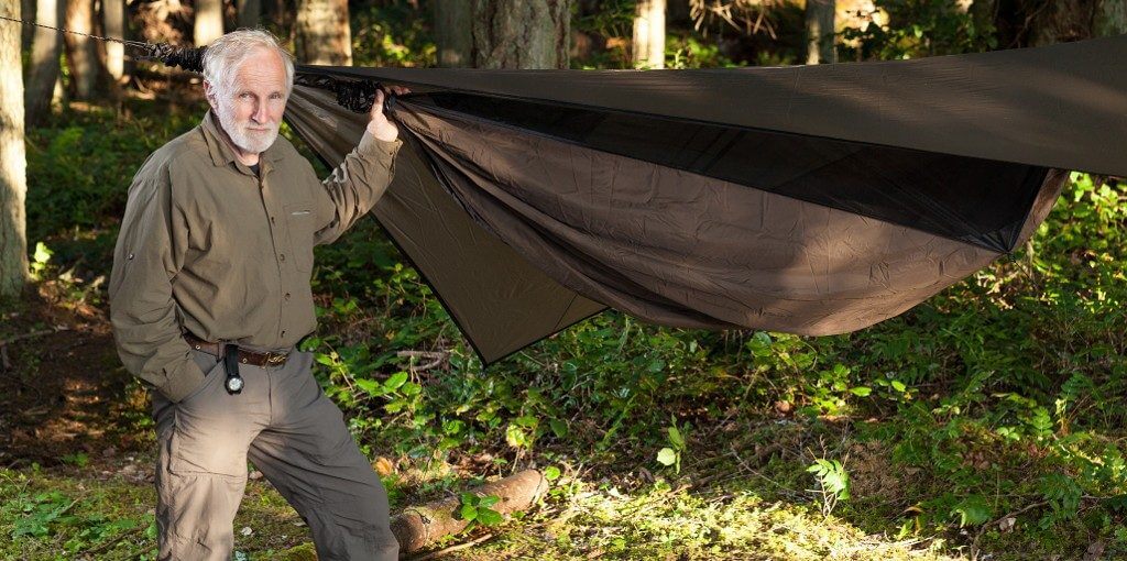 Hennessy HammockTom founder standing in the woods next to a hammock
